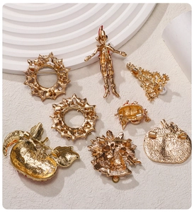 Detailed set of eight golden Christmas brooches including wreaths and trees on beige background
