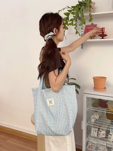 Blue gingham canvas tote bag with pink bow print and spacious shoulder strap