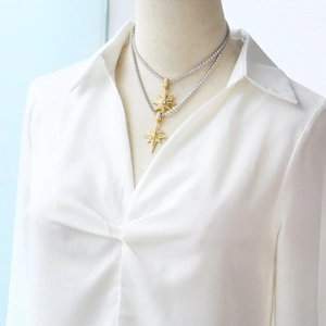 Double-layered gold star pendant necklace with cubic zirconia on a silver tennis chain
