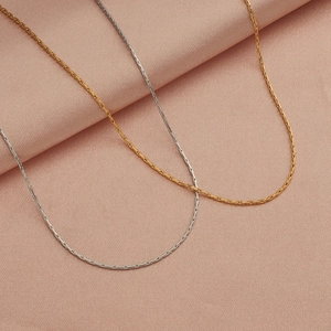 Elegant gold and silver 18k vacuum plated stainless steel chain necklaces on pink fabric