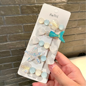 5-piece set of ocean-themed hair clips with glitter starfish, shells, and mermaid tails