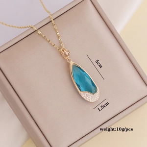 Detailed view of water drop blue pendant with size markings 5cm length and 1.5cm width