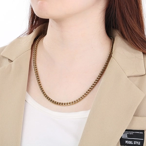 Antique gold plated curb chain necklace featuring a thick link design on a male model