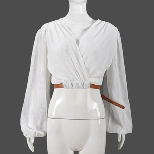 Detailed close-up of white V-neck pleated cardigan featuring a brown adjustable waist belt