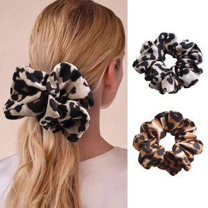 Detail of leopard print fabric scrunchies showing texture and style on hair