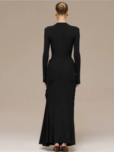 Detail of elegant black floor-length dress with waist draping and slim fishtail silhouette