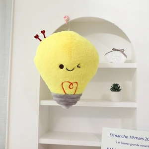 Detail of cartoon light bulb plush with heart-shaped embroidery and cute expression