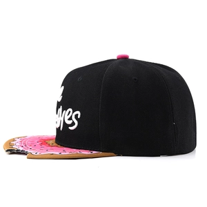 Detail of black snapback hat with donut print brim and unique bite-out notch design