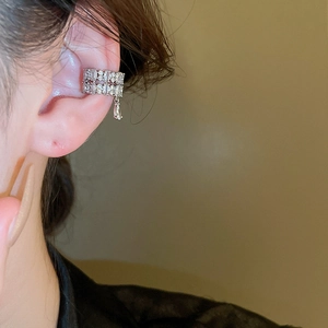 Macro detail of silver drop ear cuff with pavé cubic zirconia on double row band