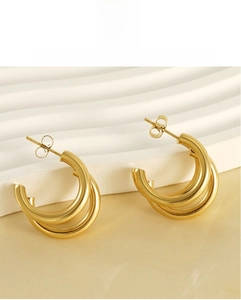 Detailed macro view of 18K gold-plated stainless steel multi-layered triple hoop earrings