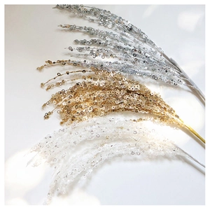 Detailed view of shimmering silver, gold, and white sequin floral branches for tree decor
