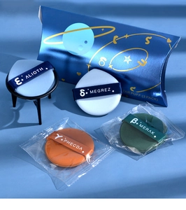 Macro shot of 4-pack makeup air cushion puffs set with branded storage case