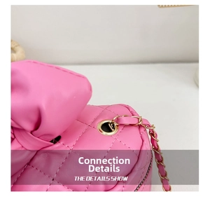 Close-up of pink quilted crossbody bag with gold chain strap detail and stitching