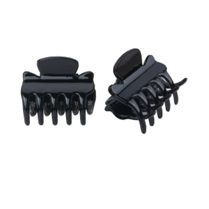 Detail of small black butterfly hair claw clips in a polished resin finish for hairstyling