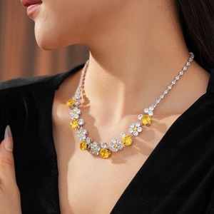 Detail of luxury flower necklace with yellow cubic zirconia on a model neck