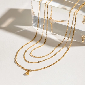 Multi-layer gold stainless steel teardrop pendant necklace with sparkling white diamonds