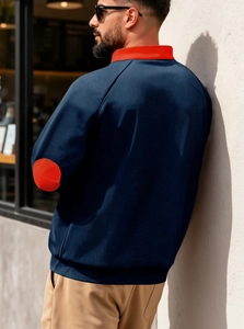 Detail of navy blue knit texture and contrasting red stand collar on men's fashion jacket