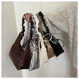 Multiple stylish ruched handle crossbody bags in five glossy metallic and neutral colors