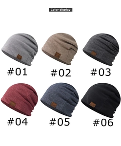 Detail view of slouchy beanie caps in six colors with F&S leather label texture