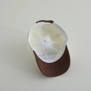 Detail view of cotton baseball cap interior showing sweatband and adjustable metal buckle