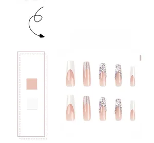 Detailed view of long French nails with white tips, floral 3D art and colorful rhinestones