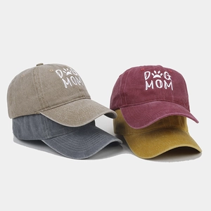 Detail of four washed cotton baseball caps in khaki, charcoal, burgundy and yellow