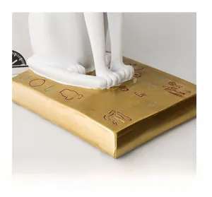 Macro detail of Egyptian cat statue base with golden finish and colored hieroglyphs