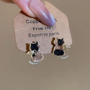Detail of leopard print cat earrings with gold plating and sparkling crystal accents