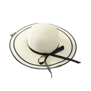 Elegant wide brim straw sun hat with black ribbon bow and trim for beach summer vacations