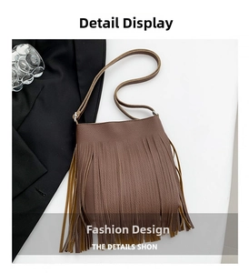 Detail shot of brown tassel shoulder bag with textured pebble grain finish and long fringe