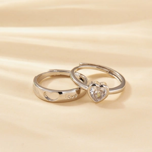 Silver couple rings set featuring heartbeat design and heart-shaped zircon stone