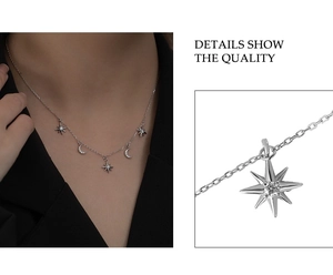 Macro detail of silver moon and star pendant necklace with sparkling crystal inlay