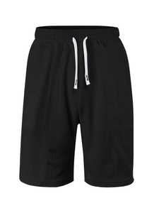 Close-up of black waffle knit fabric and white drawstring on men's leisure shorts