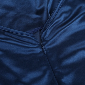 Detail of dark blue silk-like fabric with V-neckline and invisible zipper closure