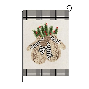 Detail of Christmas garden flag with knitted gloves, pine branches and berries pattern