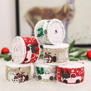 Christmas burlap ribbons in red and grey with festive patterns on a white fur surface
