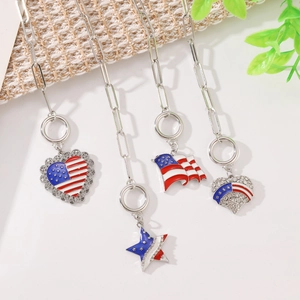 Close-up of July 4th necklaces with USA flag enamel hearts and star charms on link chains