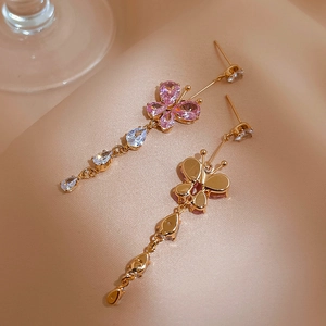 Elegant gold butterfly tassel earrings with pink and clear cubic zirconia in a 45-degree view
