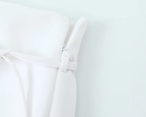 Detail of hidden zipper and belt loops on white skorts with high quality fabric texture