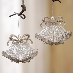 Set of two transparent Christmas bell ornaments with gold glitter on tree branches