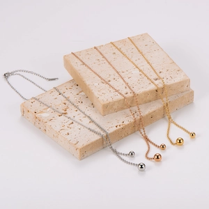 Minimalist beaded sweater necklace with gold, silver, and rose gold ball pendants