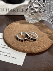 Vintage silver hoops with amber geometric resin set on a rustic cork coaster setup