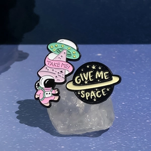 Cartoon astronaut enamel pins set featuring UFO and planet designs with space theme
