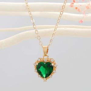 Elegant gold heart necklace with emerald green crystal and white diamond border