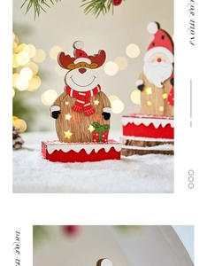 Close-up of LED glowing wooden Santa and reindeer figurines for Christmas tabletop decor