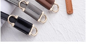 Detail of high-quality PU leather belts with gold metal D-rings in multiple colors