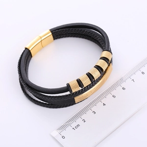 Detail view of multi-layer braided leather bracelet with gold stainless steel magnetic clasp