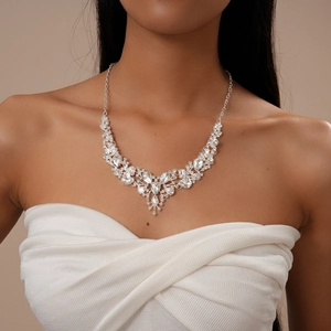 Close-up of elegant V-shaped necklace set with sparkling crystals on a model