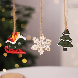 Close-up of resin Christmas tree, sled, and snowflake ornaments with hemp ropes