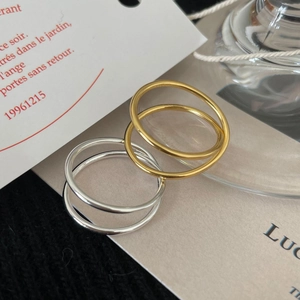 Minimalist gold and silver 925 sterling silver rings displayed on aesthetic props